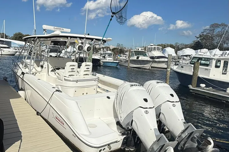 Slide: The Image of 2007 Boston Whaler 320 Outrage Cuddy Cabin docked at marina with twin engines. - 2