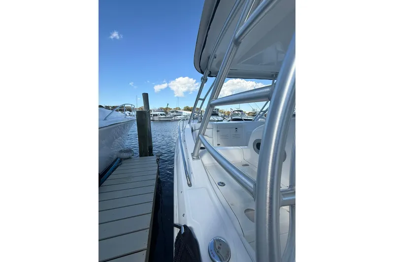 Slide: The Image of 2007 Boston Whaler 320 Outrage Cuddy Cabin docked at marina under clear sky. - 20