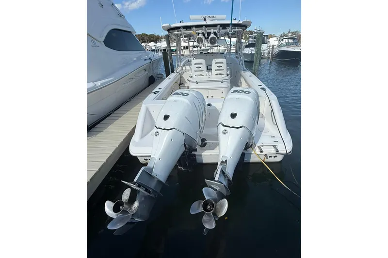 Slide: The Image of 2007 Boston Whaler 320 Outrage Cuddy Cabin with twin outboard engines docked at marina. - 22