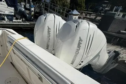 Slide: The Image of 2007 Boston Whaler 320 Outrage Cuddy Cabin with twin Mercury outboard engines docked. - 23