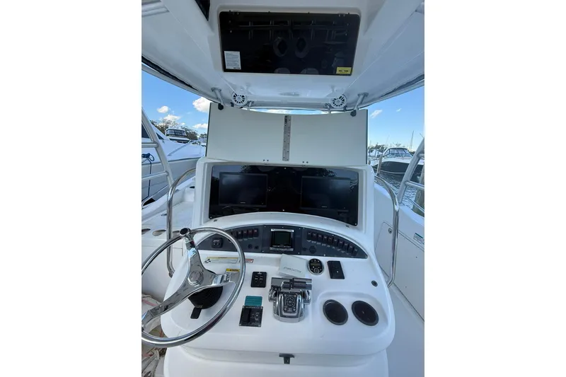 Slide: The Image of 2007 Boston Whaler 320 Outrage Cuddy Cabin helm with steering wheel and controls. - 24