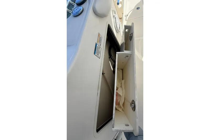Slide: The Image of Storage compartment on a 2007 Boston Whaler 320 Outrage Cuddy Cabin boat. - 28