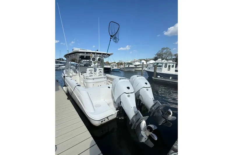 Slide: The Image of 2007 Boston Whaler 320 Outrage Cuddy Cabin docked with twin outboard engines. - 32