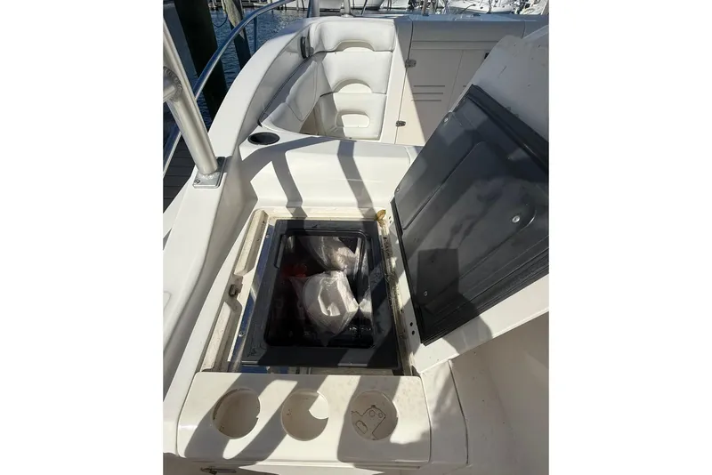 Slide: The Image of 2007 Boston Whaler 320 Outrage Cuddy Cabin interior with open storage compartment. - 33