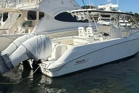 Slide: The Image of 2007 Boston Whaler 320 Outrage Cuddy Cabin docked with twin outboard engines. - 4