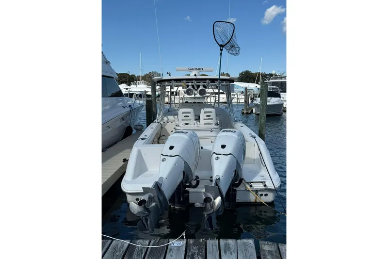 Slide: The Image of 2007 Boston Whaler 320 Outrage Cuddy Cabin docked with twin outboard engines. - 5