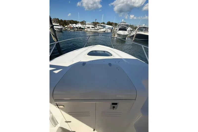 Slide: The Image of 2007 Boston Whaler 320 Outrage Cuddy Cabin at marina, clear sky, calm water. - 9