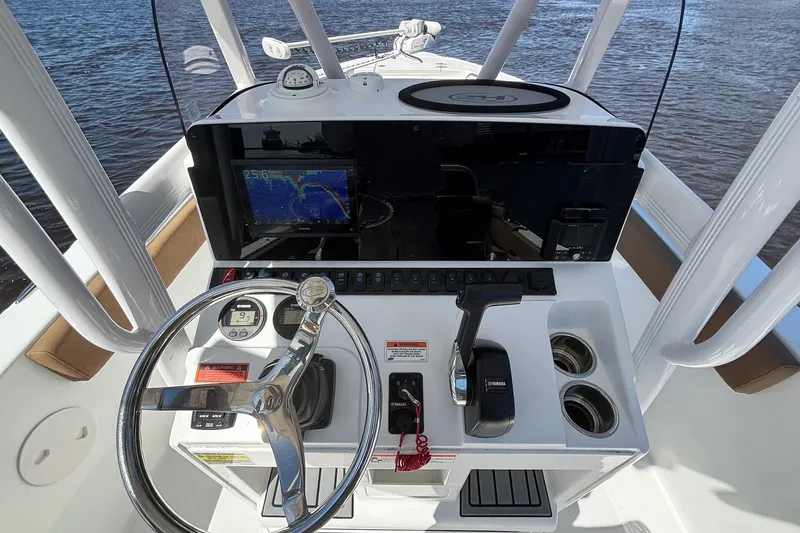 Slide: The Image of 2022 Sea Hunt Ultra 229 boat console with steering wheel and navigation display. - 10