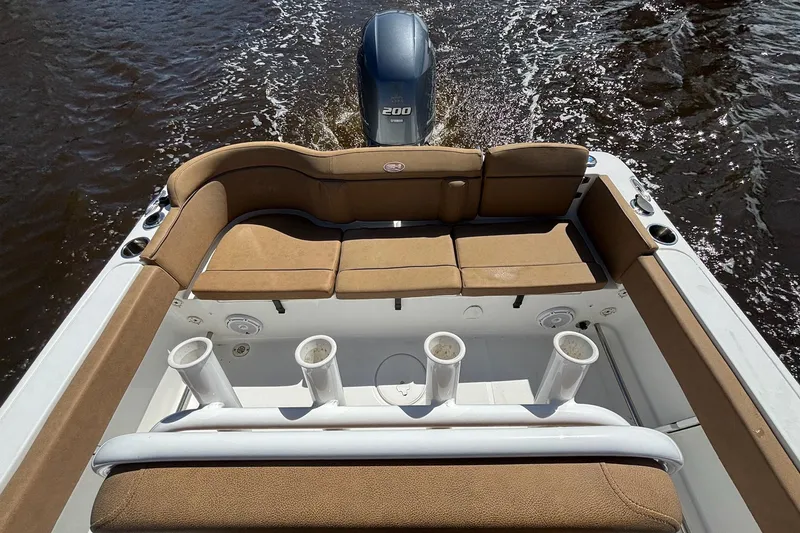 Slide: The Image of 2022 Sea Hunt Ultra 229 boat with tan seating and Yamaha 200 engine on water. - 11