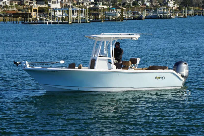 Slide: The Image of 2022 Sea Hunt Ultra 229 boat on calm water, featuring sleek design and modern amenities. - 3