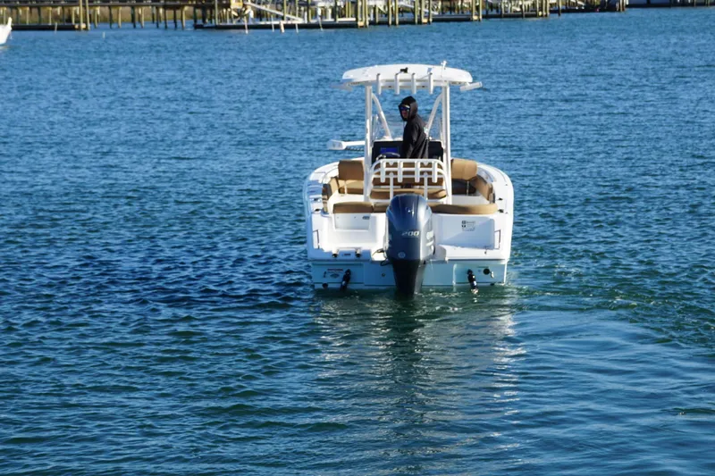 Slide: The Image of 2022 Sea Hunt Ultra 229 boat on water, rear view with outboard motor. - 9