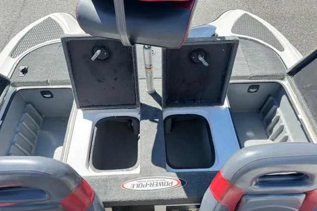 Slide: The Image of 2004 Triton Tr-186 SC boat storage compartments with open lids and seating. - 19