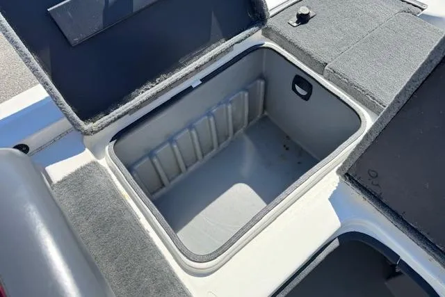 Slide: The Image of 2004 Triton Tr-186 SC boat storage compartment with open lid, showcasing interior space. - 20