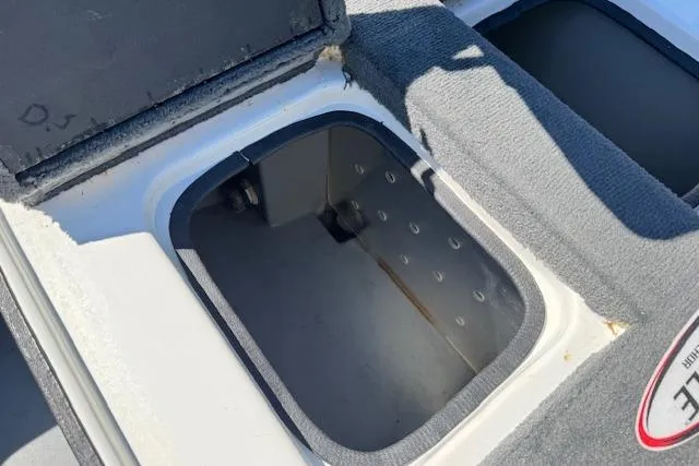 Slide: The Image of 2004 Triton Tr-186 SC boat storage compartment with open lid, showing interior details. - 21