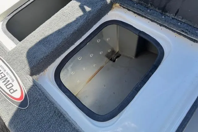 Slide: The Image of Open storage compartment on a 2004 Triton Tr-186 SC boat. - 22