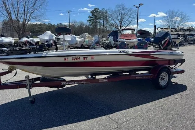 Slide: The Image of 2004 Triton Tr-186 SC boat on trailer in outdoor lot, clear sky background. - 4