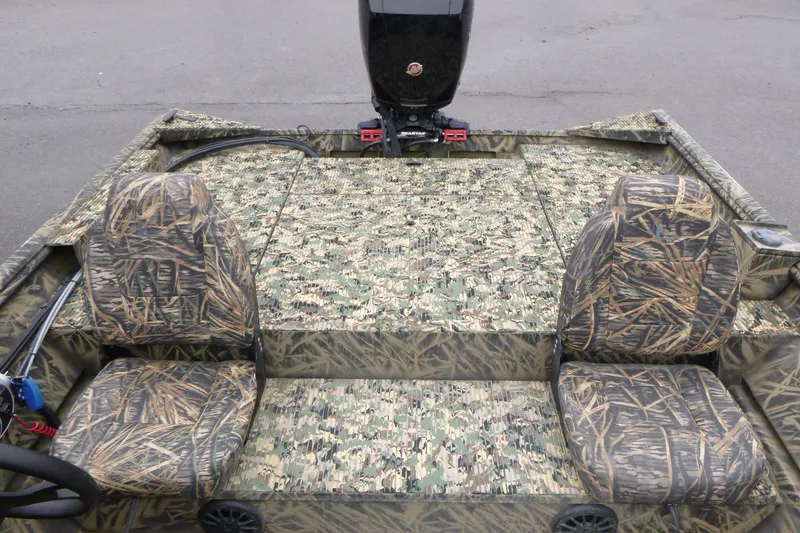 Slide: The Image of 2024 Lowe Roughneck 2070 boat interior with camouflage seating and flooring design. - 10