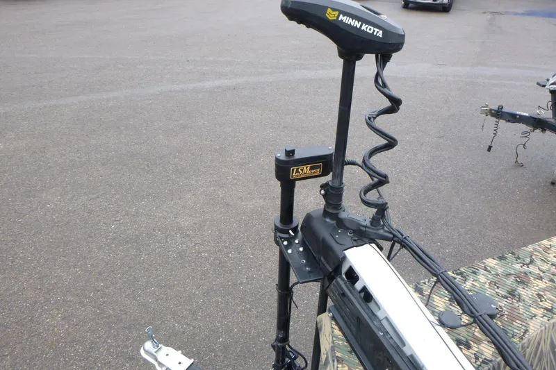 Slide: The Image of 2024 Lowe Roughneck 2070 with Minn Kota trolling motor and LSMount on pavement. - 12