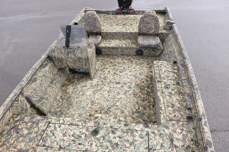 Slide: The Image of 2024 Lowe Roughneck 2070 boat with camouflage interior design, featuring seating and console. - 19