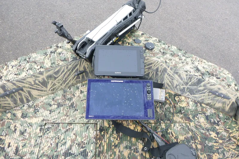 Slide: The Image of 2024 Lowe Roughneck 2070 boat with camouflage deck and electronic navigation equipment. - 20