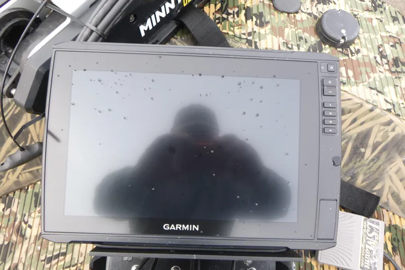 Slide: The Image of Garmin display on 2024 Lowe Roughneck 2070 boat with camo background and Minn Kota equipment. - 21