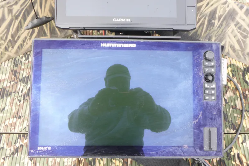 Slide: The Image of Humminbird Solix 15 fish finder on 2024 Lowe Roughneck 2070 boat, with Garmin device above. - 22