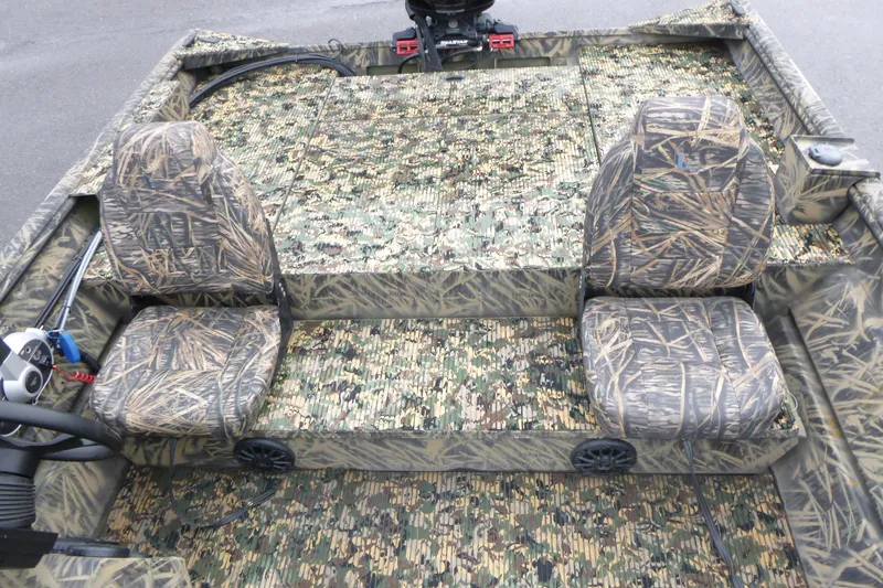 Slide: The Image of 2024 Lowe Roughneck 2070 boat interior with camouflage seating and flooring design. - 24