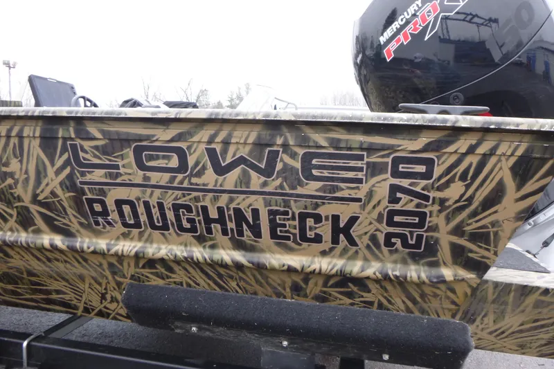 Slide: The Image of 2024 Lowe Roughneck 2070 boat with camouflage design and Mercury Pro motor. - 3