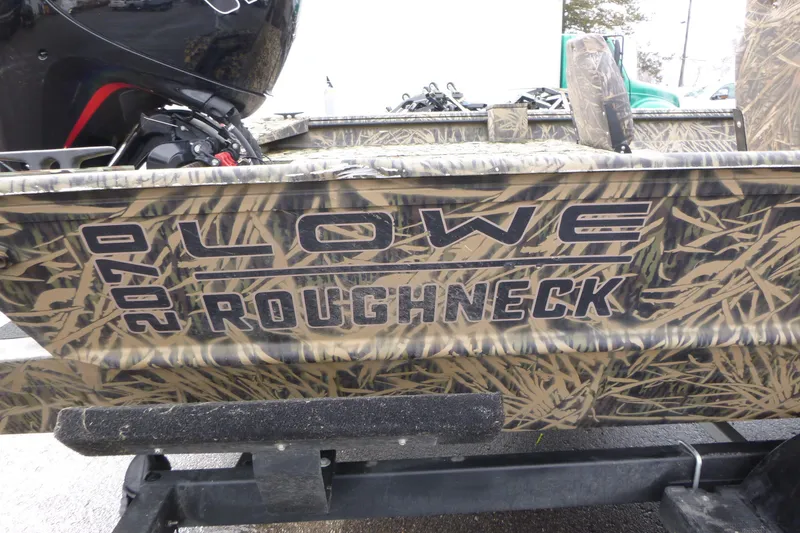 Slide: The Image of 2024 Lowe Roughneck 2070 boat with camouflage design on a trailer. - 30