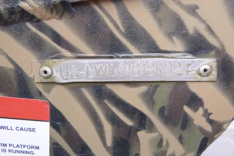 Slide: The Image of 2024 Lowe Roughneck 2070 boat with camouflage pattern and visible hull identification number. - 31