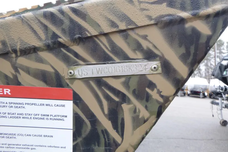 Slide: The Image of 2024 Lowe Roughneck 2070 boat with camouflage pattern and identification plate. - 5