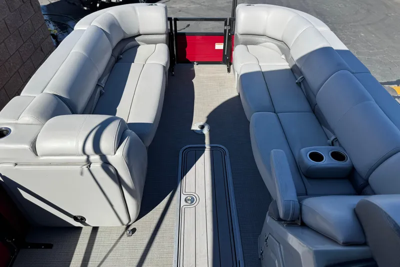 Slide: The Image of 2023 Regency 250 DL3 pontoon boat interior with plush seating and cup holders. - 10