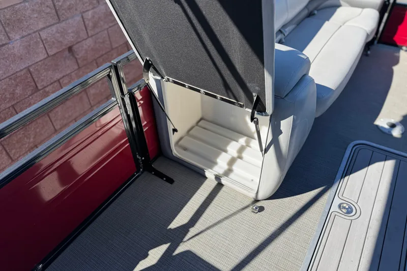 Slide: The Image of 2023 Regency 250 DL3 boat interior with open storage compartment and seating. - 12