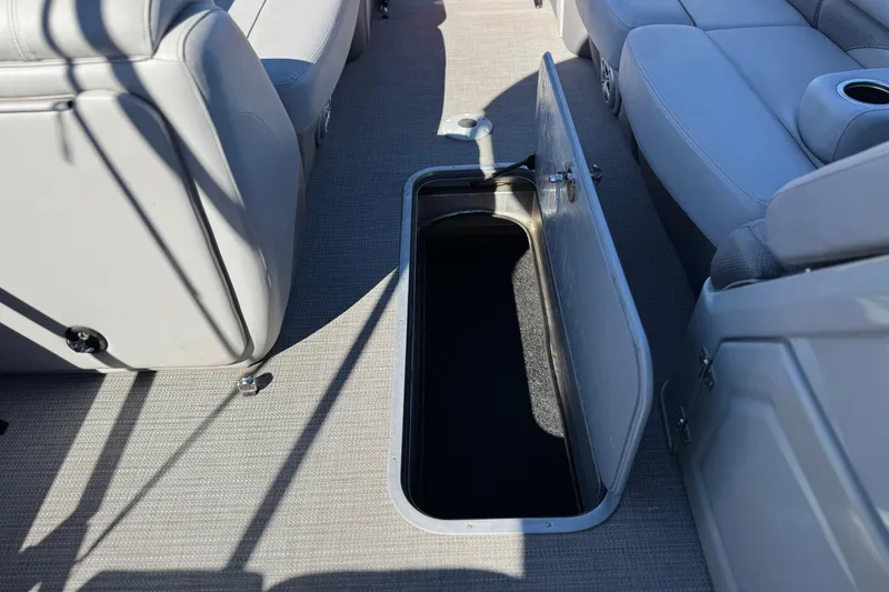 Slide: The Image of 2023 Regency 250 DL3 boat interior with open storage compartment and seating. - 17