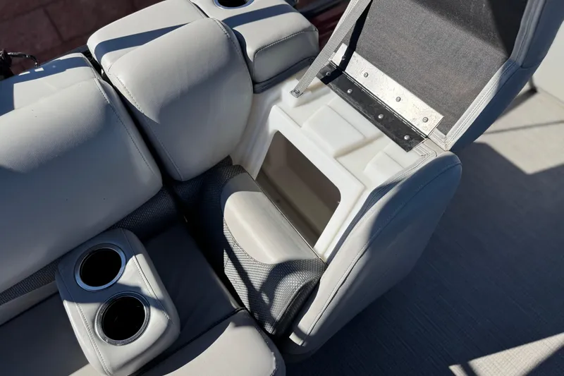 Slide: The Image of 2023 Regency 250 DL3 boat seat with storage compartment and cup holders. - 19