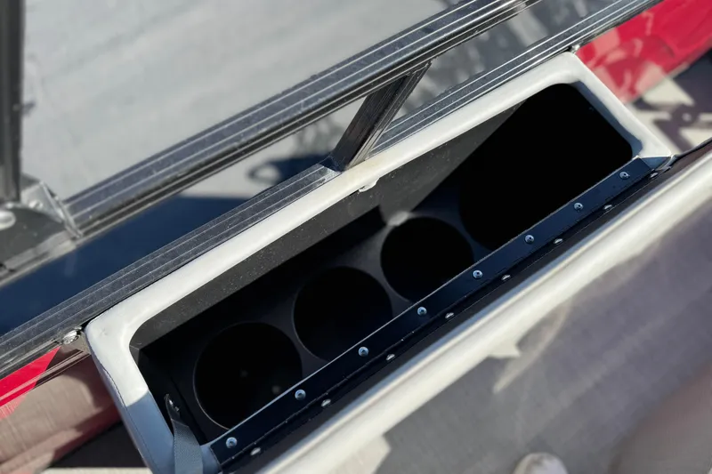 Slide: The Image of Storage compartment on 2023 Regency 250 DL3 boat, featuring cup holders. - 21