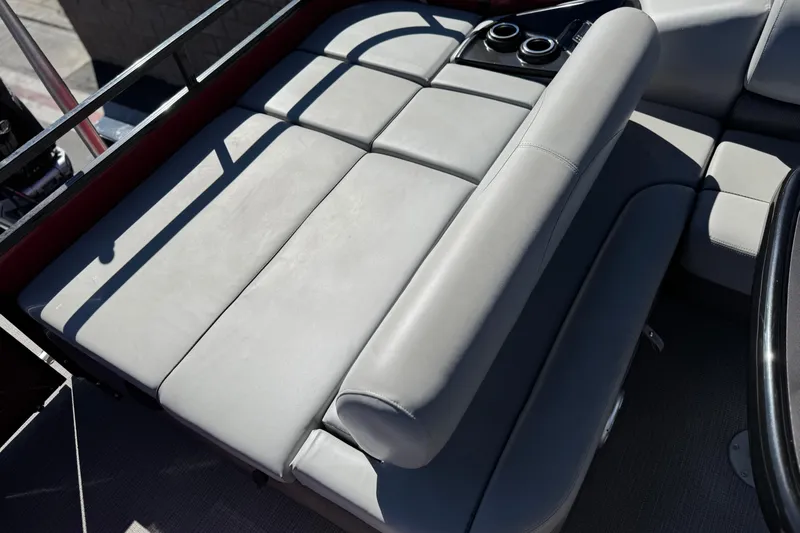 Slide: The Image of 2023 Regency 250 DL3 boat interior with gray cushioned seating and cup holders. - 22