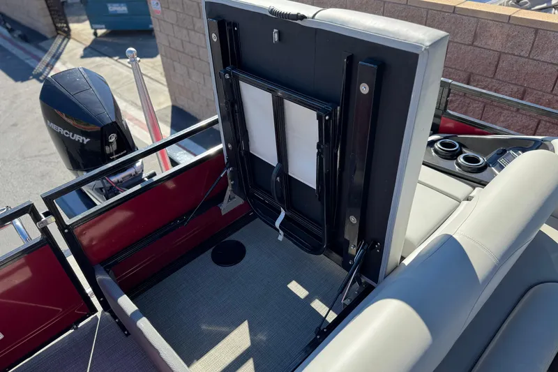 Slide: The Image of 2023 Regency 250 DL3 boat interior with Mercury engine, featuring seating and storage area. - 24