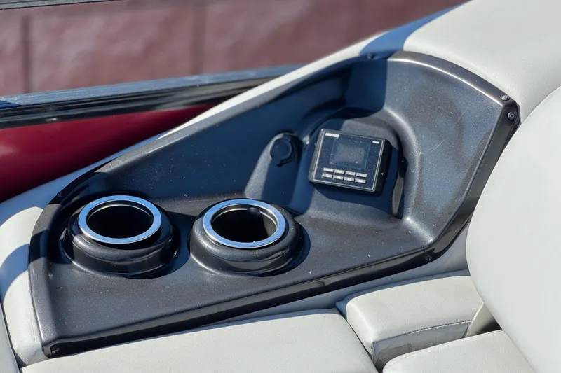 Slide: The Image of 2023 Regency 250 DL3 boat console with cup holders and control panel. - 25