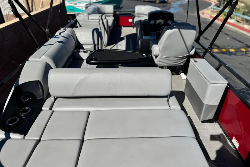 Slide: The Image of 2023 Regency 250 DL3 pontoon boat interior with luxurious seating and modern design. - 27
