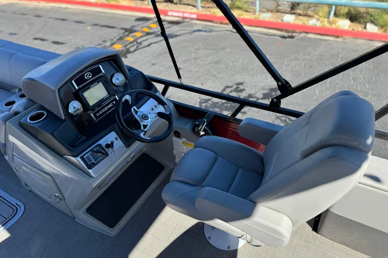 Slide: The Image of 2023 Regency 250 DL3 boat helm with steering wheel and captain's chair. - 28