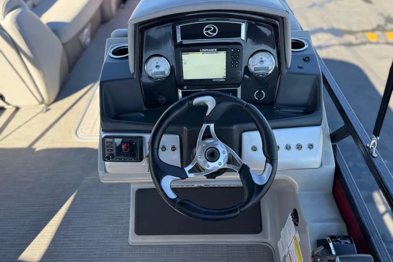 Slide: The Image of 2023 Regency 250 DL3 boat dashboard with steering wheel and navigation system. - 29