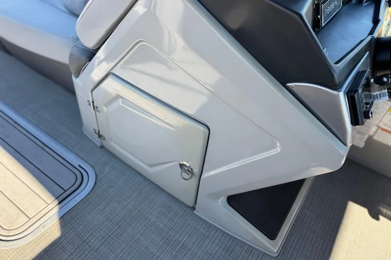 Slide: The Image of 2023 Regency 250 DL3 boat console with storage compartment and seating area. - 32