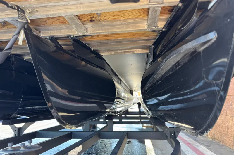 Slide: The Image of Underneath view of a 2023 Regency 250 DL3 pontoon boat on a trailer. - 4