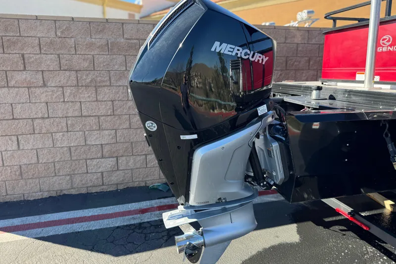 Slide: The Image of 2023 Regency 250 DL3 boat with Mercury outboard motor, parked outdoors. - 7