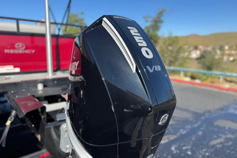 Slide: The Image of 2023 Regency 250 DL3 boat with Mercury 250 V8 engine, outdoor setting. - 8