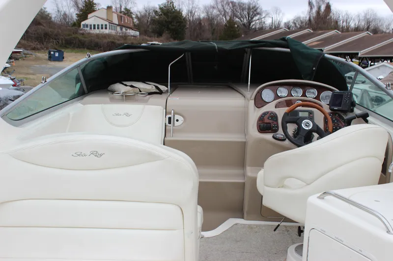 Slide: The Image of 2005 Sea Ray Sundancer 280 cockpit with steering wheel and dashboard controls. - 10