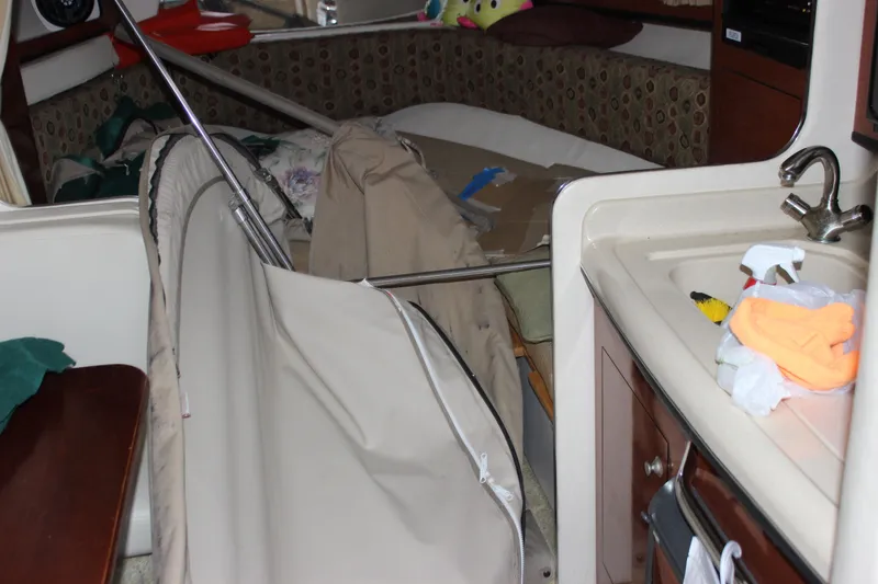 Slide: The Image of Interior of a 2005 Sea Ray Sundancer 280 boat with cluttered cabin space. - 14