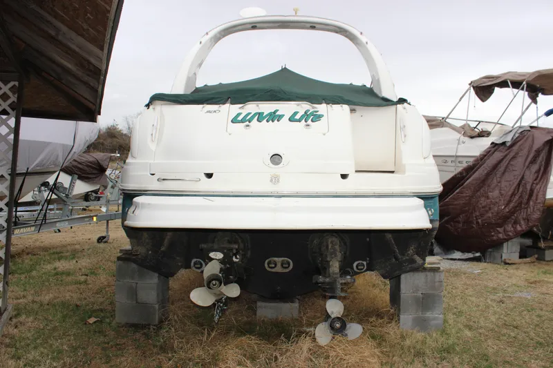 Slide: The Image of 2005 Sea Ray Sundancer 280 boat on blocks, rear view with covered deck. - 4