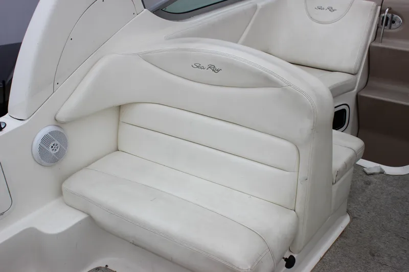Slide: The Image of 2005 Sea Ray Sundancer 280 interior seating with white upholstery and speaker detail. - 6